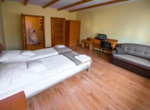 a bedroom with a large bed and a couch at Pokoje Gościnne Barbara Wacławska in Iława