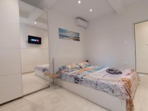 Postel nebo postele na pokoji v ubytování Sea Pleasure Apartment