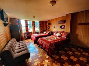 a bedroom with two beds and a couch at Dream Garden Mountain Hotel in San Juan