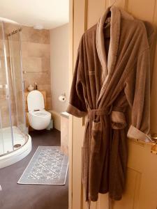 a bathroom with a towel hanging on a door at Bootmenders B&B in Petersfield