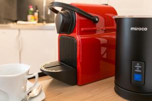 a red and black toaster sitting on a counter at Spirit Apartments - Neben dem Titlis - Parkplatz in Engelberg