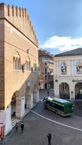 a green bus is parked in front of a building at Palazzina300 in Treviso