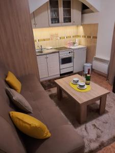 a living room with a couch and a table at Apartman Rada 2 in Bijeljina