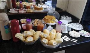 a buffet of pastries and drinks on a table at Hotel Flert Santana in Sao Paulo