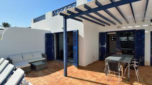 een patio met een bank en een tafel en stoelen bij Coloradas29 in Playa Blanca