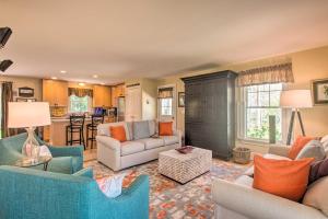 a living room with couches and a kitchen at Traditional Marthas Vineyard Home with Porch and Yard in Oak Bluffs