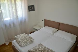 Ένα ή περισσότερα κρεβάτια σε δωμάτιο στο Appartamento AL CENTRO