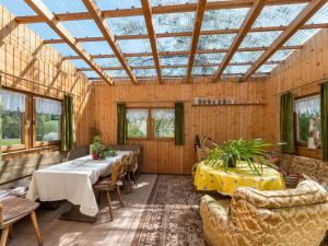 a conservatory with a table and chairs and a glass ceiling at Quaint Holiday Home in Bad K tzting with Garden Terrace in Bad Koetzting