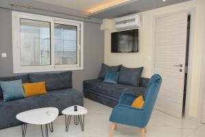 a living room with a couch and a table at Princess Luxury Suite 2 in Paralia Katerinis