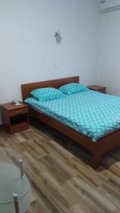 a bedroom with a bed and a glass table at Vržina Farm House Skadar Lake in Virpazar