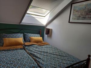 a bedroom with a bed and a skylight at house Paola in Tribalj +34 photos