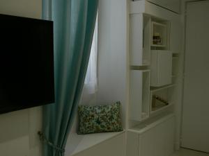 a pillow sitting on a window sill next to a curtain at Stone studio in Saint-Tropez