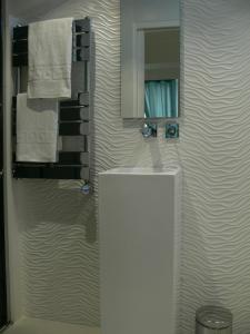 a bathroom with a sink and a mirror and towels at Stone studio in Saint-Tropez