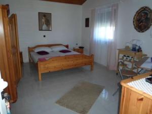 a bedroom with a bed in a room with a table at Studio Apartment in Nin with Terrace, Air Conditioning, Wi-Fi (233-2) in Nin