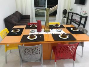a dining room table with plates of food on it at Refugio Villa Verona Praia do Forte in Mata de Sao Joao