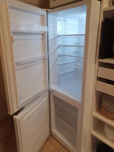 an empty refrigerator with its door open in a kitchen at Rialahästgård in Uddeby