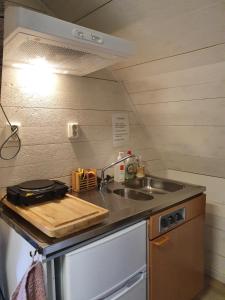 a kitchen with a sink and a counter top at Rialahästgård in Uddeby