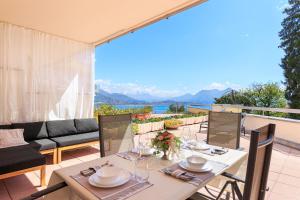 a table and chairs on a patio with a view at Aurum in Baveno