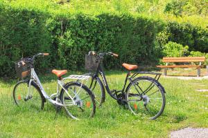 two bikes parked in the grass next to a bench at Aurum in Baveno