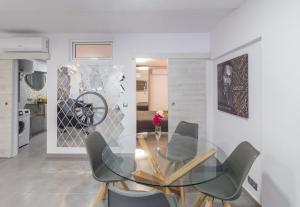 a dining room with a glass table and chairs at Holiday Home Alexia Oceanfront in San Bartolomé de Tirajana