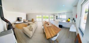 a living room with a couch and a table at FamilyHost Charm Porto Covo in Porto Covo
