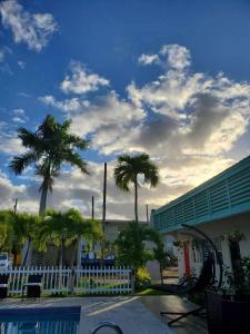 a group of palm trees in front of a building at Georges Royal Inn in Frederiksted