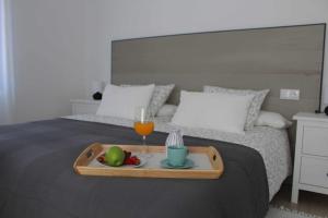 A bed or beds in a room at Viviendas turísticas San Juan