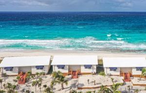 an aerial view of a beach with chairs and the ocean at St Francis Resort in Georgetown