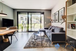 a living room with a couch and a table at Dom FANØ Baltic 2 - Aprent in Pobierowo