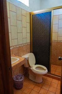 a bathroom with a toilet and a sink and a shower at Balneario y Cabañas ISIS in La Huerta +28 photos