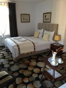 a bedroom with a large bed and a table at Rewa in Rewal +97 photos
