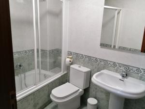 a bathroom with a toilet and a sink and a shower at Cuatro Caminos in Sarria +27 photos