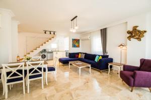 a living room with a couch and a table at Garden Court Apartments in Kalkan