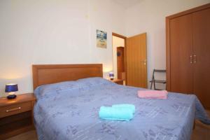 a bedroom with a blue bed with two towels on it at Apartment in Porec/Istrien 10068 in Poreč