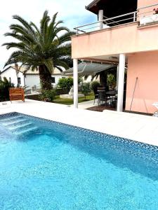 a swimming pool in front of a house at D&A Apartment with private swimming pool in Pula
