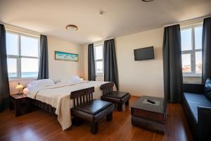 a hotel room with a bed, chair, desk and a window at Hotel Viking in Hafnarfjörður