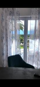 a chair sitting in front of a window at D&A Apartment with private swimming pool in Pula