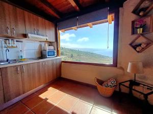a kitchen with a large window in a room at Apartamento Maudes de StarApsTenerife in Sauzal