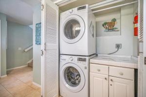 a laundry room with a washer and dryer at Makahuena at Poipu in Koloa