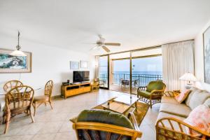 a living room with a couch and chairs at Nohonani 306 in Kahana