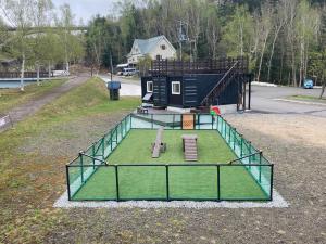 an aerial view of a tiny house with a batting cage at C HOTEL 美瑛白金 - Biei Shirogane in Biei