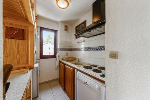 a small kitchen with a stove and a sink at Appartement montagnard à Bolquère, 57m², vue montagne, balcon in Bolquere Pyrenees 2000