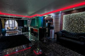 a lobby with a bar with black furniture and red lighting at Ag Şişli Hotel in Istanbul