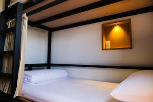a bedroom with two bunk beds and a mirror at 台灣潛水綠島店 Green Island Dive in Green Island