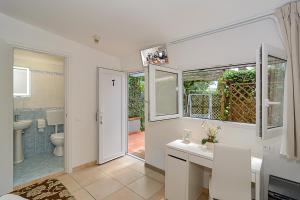 a bathroom with a toilet and a sink and a mirror at Hotel Storyville Business & Holiday in Cinquale +122 photos