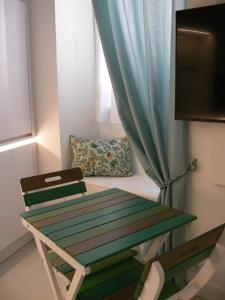 a table and a chair in a room with a window at Stone studio in Saint-Tropez