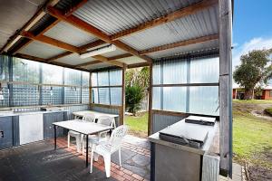 a patio with a table and a table and chairs at Allestree Holiday Units in Portland