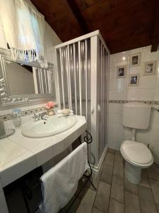 bagno bianco con servizi igienici e lavandino di Stecadó - il Soppalco a Dolceacqua