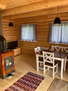 a living room with a wood stove and a table at Drevenica Magdaléna in Trstené