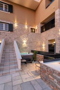 a patio with stairs and a tub in front of a building at TEONA Luxury Studio Apartment with jacuzzi and terrace sea view in Sali